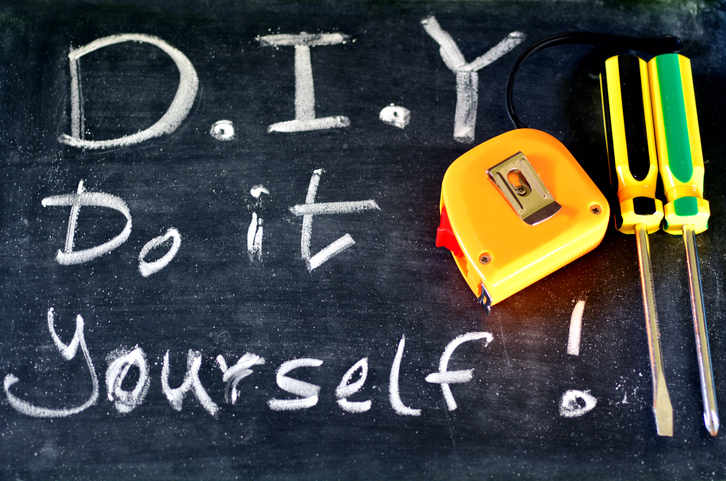 This is a black chalkboard with white chalk lettering that spell out D.I.Y Do It Yourself.